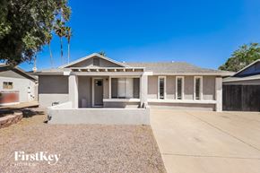 Glendale house for rent - A house with a gravel driveway in front of it.