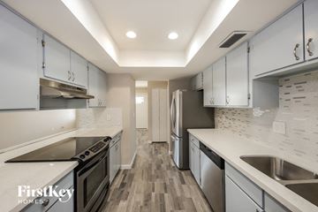 Glendale house for rent - A kitchen with a stove top oven, a refrigerator, and a sink.