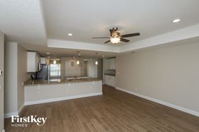 Palm Bay house for rent - an empty living room and kitchen with a ceiling fan