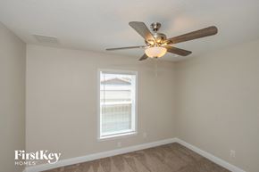 Palm Bay house for rent - a bedroom with a ceiling fan and a window