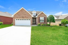 Clarksville house for rent - a large brick house with a white driveway and lawn