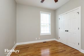 Clarksville house for rent - a bedroom with a hard wood floor and a white door