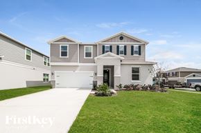 Winter Haven house for rent - a white house with a lawn in front of it