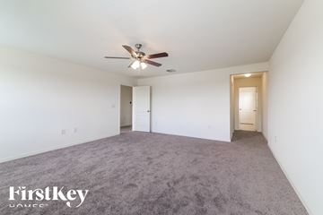 Winter Haven house for rent - a living room with carpet and a ceiling fan