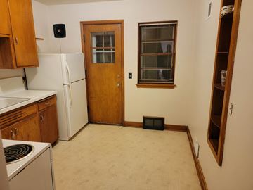 South Milwaukee apartment for rent - a kitchen with a stove refrigerator and a door