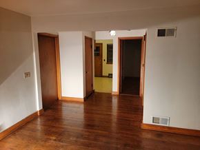 South Milwaukee apartment for rent - a living room with wood floors and a door to a hallway
