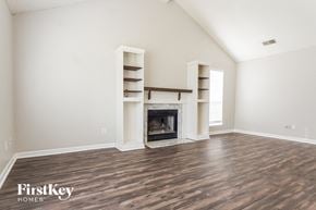 Helena house for rent - the living room with wood flooring and a fireplace