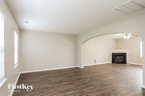 Durham house for rent - A spacious living room with a fireplace and wood flooring.