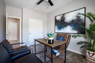 Phoenix apartment for rent - a living room with a table and chairs and a ceiling fan