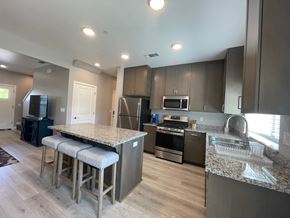 Chico apartment for rent - A kitchen with a granite countertop and stainless steel appliances.