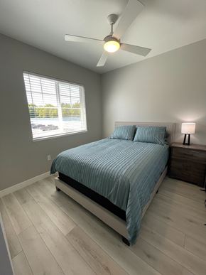 Chico apartment for rent - A bedroom with a bed, nightstand, and window.