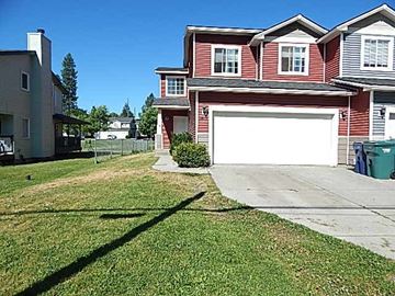 Coeur D' Alene house for rent - a red house with a white garage door