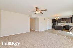 Peyton house for rent - A spacious living room with a ceiling fan and a dining area in the background.