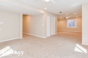 Peyton house for rent - A spacious room with a carpeted floor and a window with blinds.