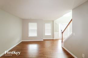 Lawrenceville house for rent - a living room with wood floors and white walls and a staircase