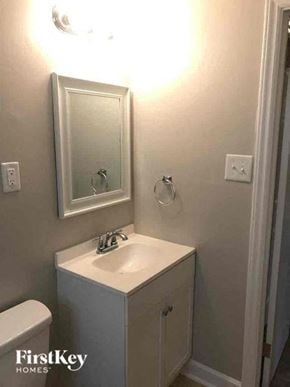 Gastonia house for rent - a white bathroom with a sink and a mirror