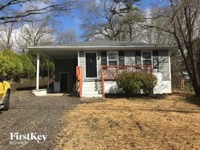 Gastonia house for rent - a small white house with a porch and some trees
