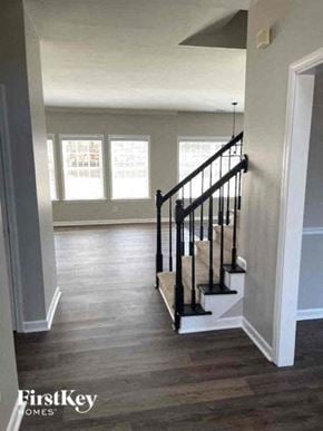 Dacula house for rent - a living room with a staircase and a hard wood floor
