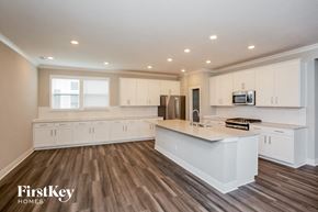 Westfield house for rent - a large kitchen with white cabinets and a white counter top