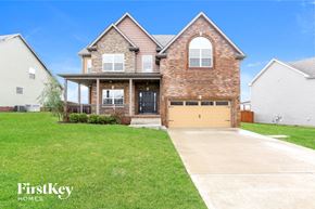 Clarksville house for rent - a large brick house with a yellow garage door