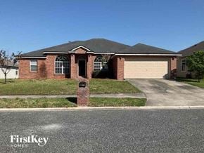 Middleburg house for rent - A brick house with a garage door and a mailbox on the left side.