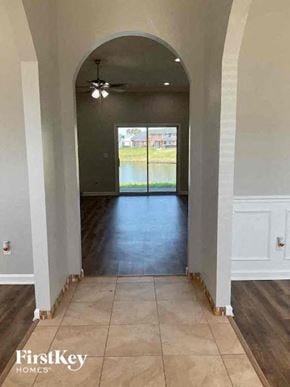 Middleburg house for rent - A hallway with a view of a lake through a glass door.