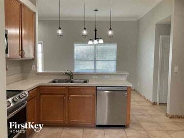 Middleburg house for rent - A kitchen with wooden cabinets and a stainless steel dishwasher.