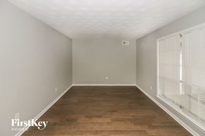 Memphis house for rent - a bedroom with wood flooring and a large window