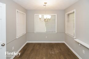 Memphis house for rent - the dining room of a home with wood flooring and a large window