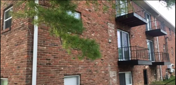 Indianapolis apartment for rent - a brick building with a tree growing on the side of it