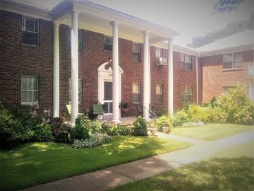 Memphis apartment for rent - A red brick building with a porch and a white roof.