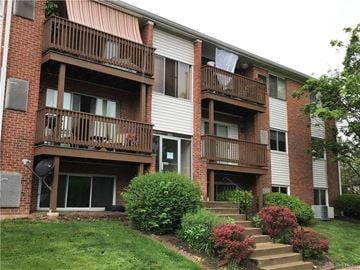 Dayton house for rent - a brick apartment building with stairs and balconies