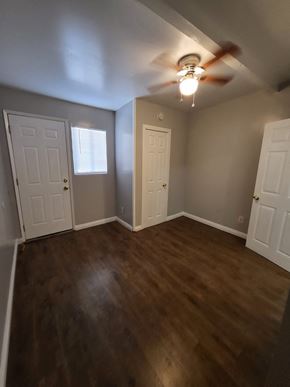 Ontario apartment for rent - an empty living room with wooden floors and a ceiling fan