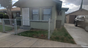 Ontario apartment for rent - a house with a fence and a car parked in front of it