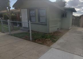 Ontario apartment for rent - a house with a fenced in yard and a chain link fence