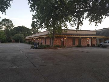 Lake Charles apartment for rent - an empty parking lot in front of a brick building