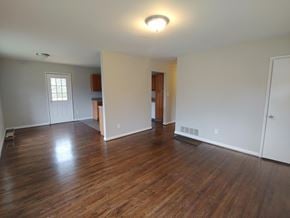 Bessemer house for rent - an empty living room with wood floors and white walls