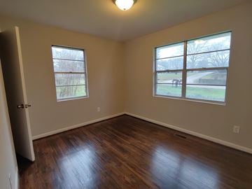 Bessemer house for rent - a bedroom with a hard wood floor and two windows
