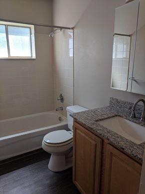 Broomfield apartment for rent - a bathroom with a toilet and a tub and a sink
