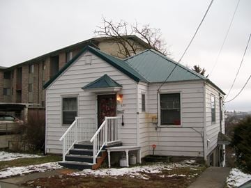 Pullman apartment for rent - a small white church with a green roof and stairs in the snow
