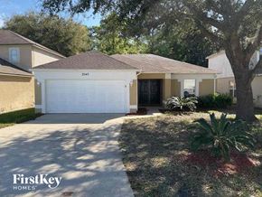 Jacksonville house for rent - A house with a garage and a tree in front of it.