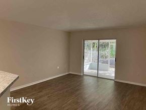 Jacksonville house for rent - A room with a sliding glass door leading to a balcony.