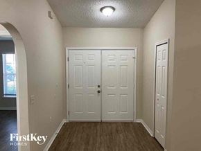 Jacksonville house for rent - A room with a white door and a window.