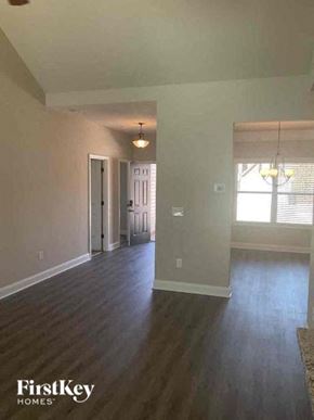 Dallas house for rent - an empty living room with a hard wood floor