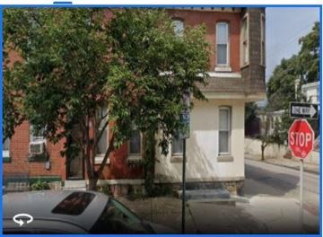 Phila apartment for rent - a stop sign on a street in front of a house