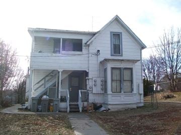 Pullman apartment for rent - a white house with a porch and a sidewalk