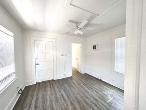Santa Cruz apartment for rent - an empty living room with white walls and a ceiling fan