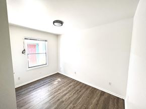 Santa Cruz apartment for rent - an empty room with white walls and a window and wood floors