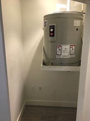 Vancouver apartment for rent - A water heater installed in a narrow hallway.
