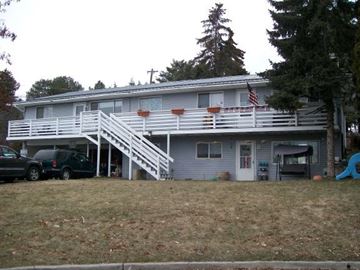 Pullman apartment for rent - A house with a car parked in front and a tree in the backyard.